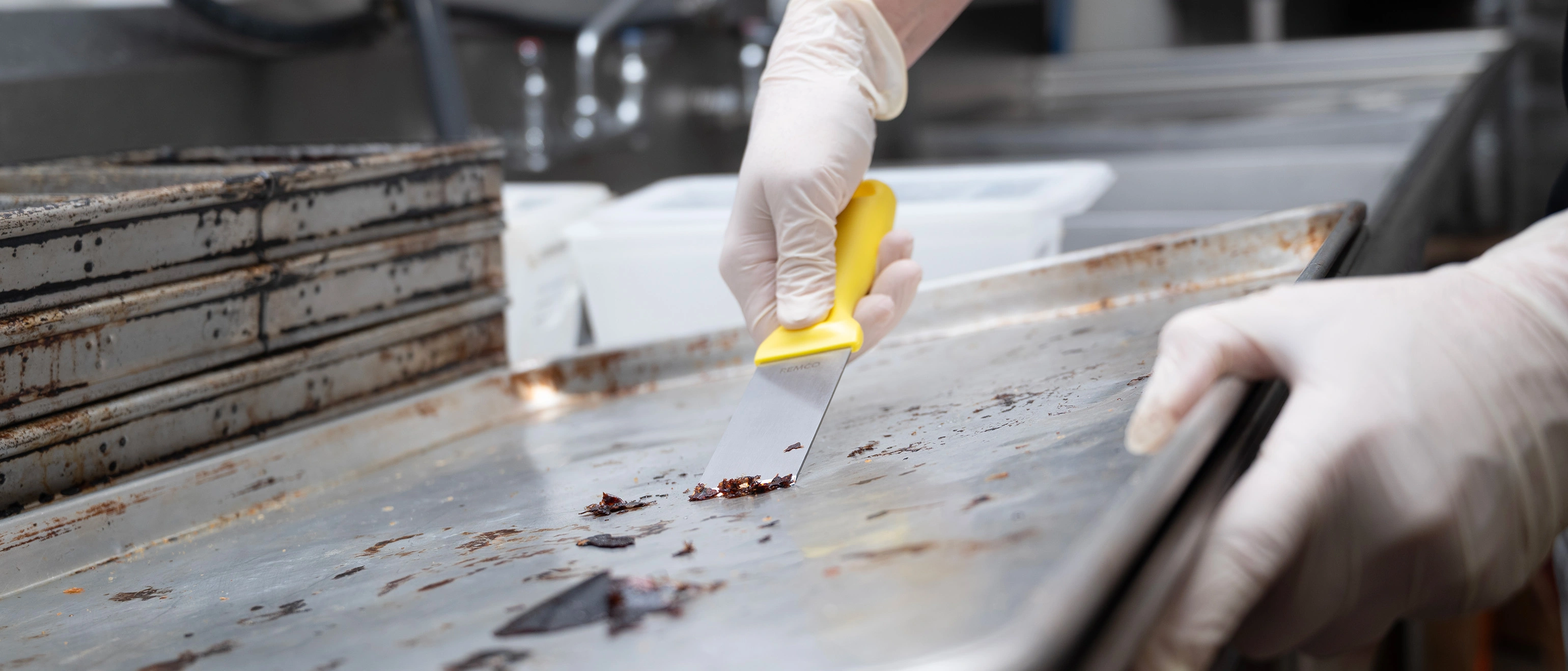 Vikan stainless steel hand scraper in use